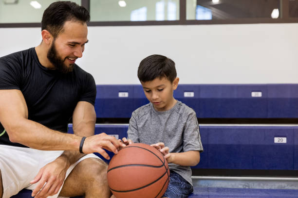 istock Dad listens while son holds basketball and shares his thoughts 1168467463