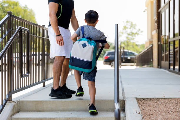 istock Unrecognizable uncle waits for young nephew to go up steps 1168467507