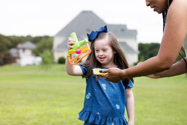 istock Unrecognizable therapist helps young girl make bubbles 1168467590