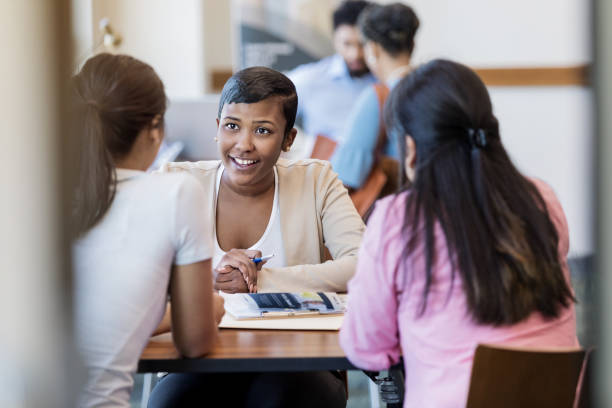 istock Friendly bank employee meets with clients 1168467771