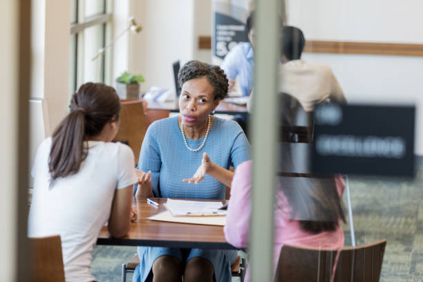 istock Serious loan officer talking with female customer 1168467785