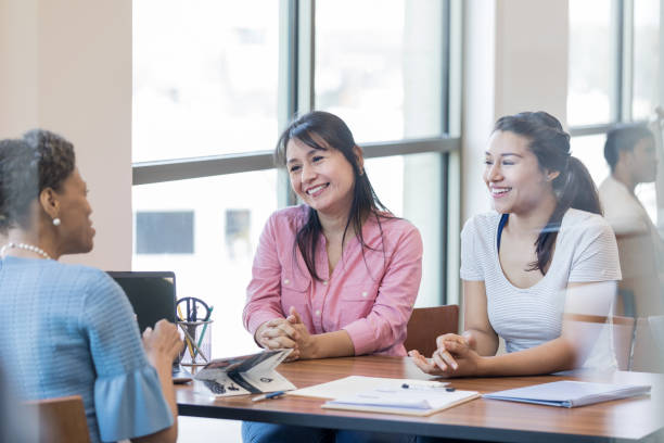 istock Attentive women talking with bank officer 1168467796