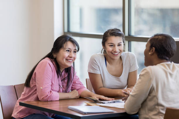 istock Mom and daughter talk with loan officer 1168467800