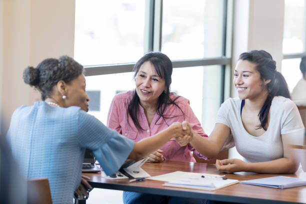 istock Loan officer shaking hands with customer 1168467803