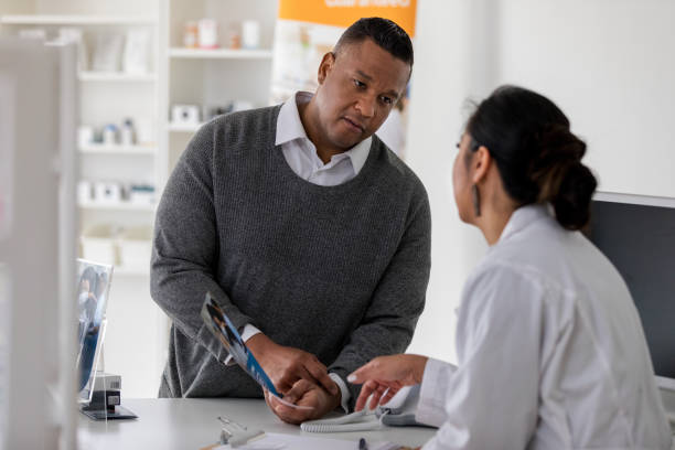 istock Pharmacist clarifies information in brochure customer holds 1168467822