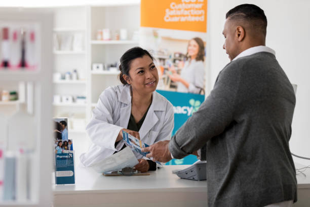 istock Pharmacist smiles and listens as customer asks question about vaccine 1168467831