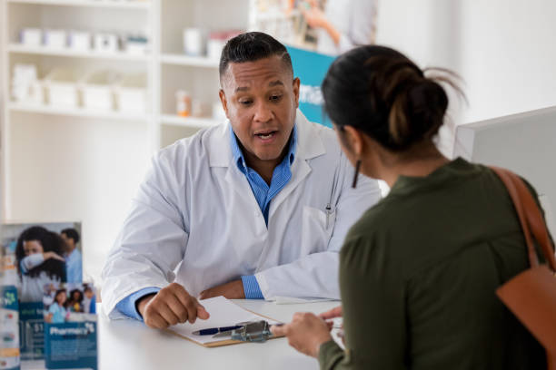 istock Mature adult pharmacist explains drug interactions to unrecognizable customer 1168467841