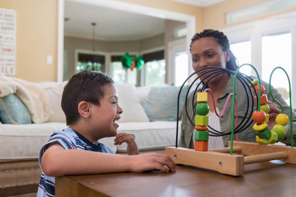 istock Boy with Down Syndrome works with play therapist 1168468358