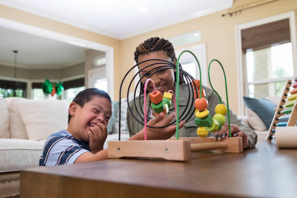 istock Excited boy with Down Syndrome plays with his mom 1168468359
