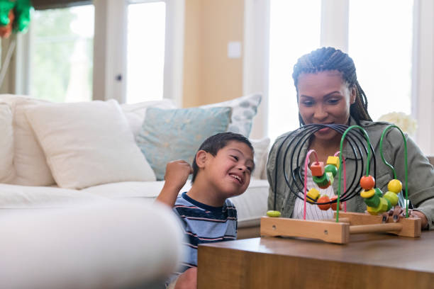istock Boy with special needs plays with his mom 1168468362