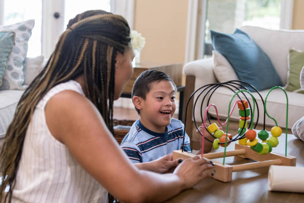 istock Happy young boy playing with bead maze 1168468363