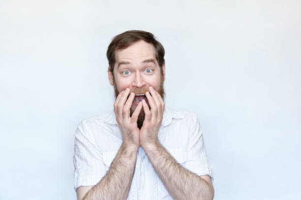 istock Happy bearded man covering the mouth with hand 1168469062