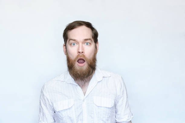istock Surprised bearded man with mouth open over gray background 1168469067