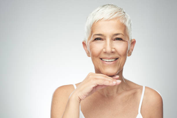 istock Senior woman posing in front of gray background. 1168469265