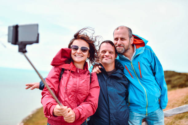 istock Family With Disabled Child Taking Selfie 1168470028