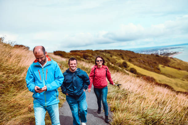 istock Father Taking A Walk With Daughter And Disabled Son 1168470054