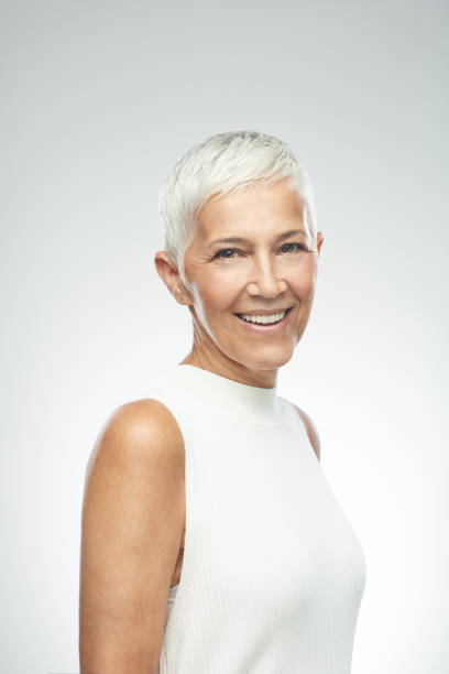 istock Senior woman posing in front of gray background. 1168470247