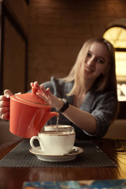 istock woman with teapot 1168471588