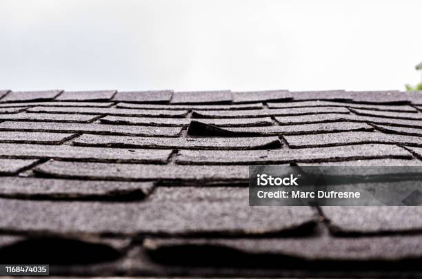 Closeup On Damaged Asphalt Shingles Stock Photo - Download Image Now - Rooftop, Roof Tile, Wood Shingle