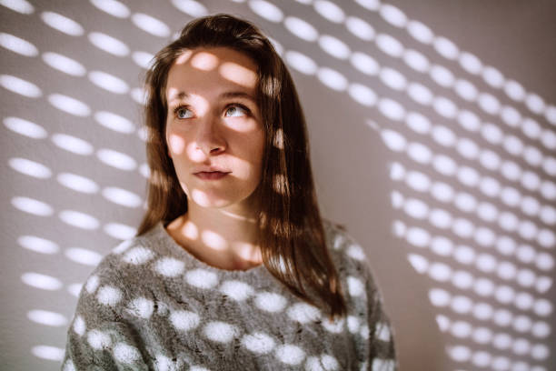 istock Pretty Brunette Woman Behind Sun-blind Shadow 1168475106