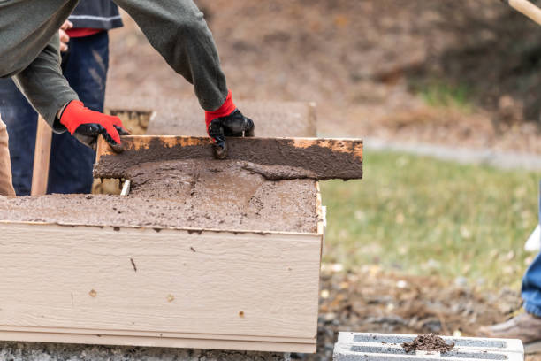 istock Construction Worker Leveling Wet Cement Into Wood Framing 1168476075