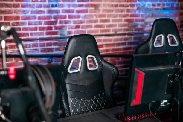 Empty Gaming Chairs at an Esports Venue Empty gaming chairs and gaming stations at an esports venue. gaming chair photos stock pictures, royalty-free photos & images