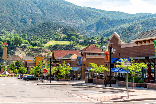 Glenwood Springs, USA - June 29, 2019: Shopping meadows mall park buildings stores in Colorado town near red mountain and cars parked