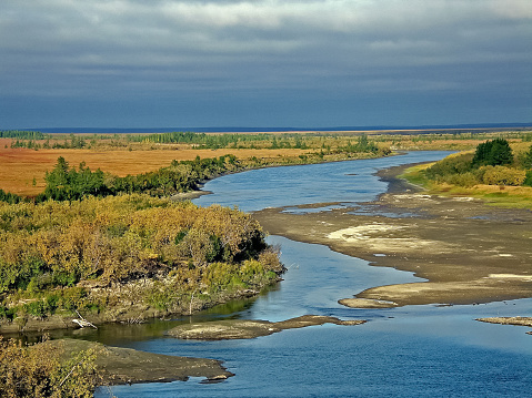 The scenic vista point shows Alaska in its Spring season. Snow runoff has muddied the Matanuska river. The Chugach mountains rise up in beauty and splendor making this vista point a stopping point for many.