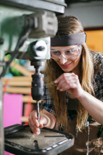 istock woman wearing safety glasses working in a workshop 1168483776