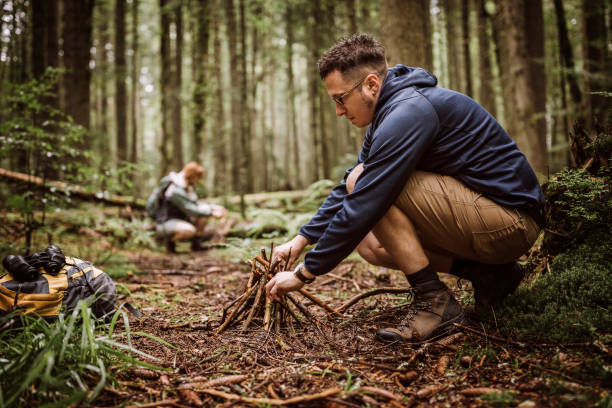istock Couple making campfire in woodland 1168484601