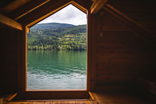 Majestic view from wooden house on the lake, view from window