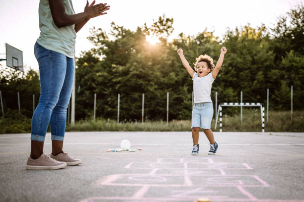 istock Cheerful children playing hopscotch on school yard 1168485385