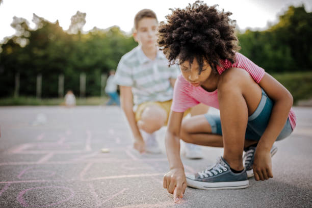 istock Kids drawing with chalk on asphalt 1168485399