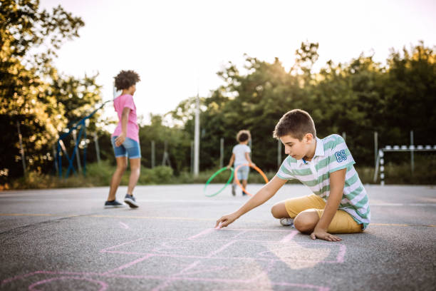 istock Kids drawing with chalk on asphalt 1168485400