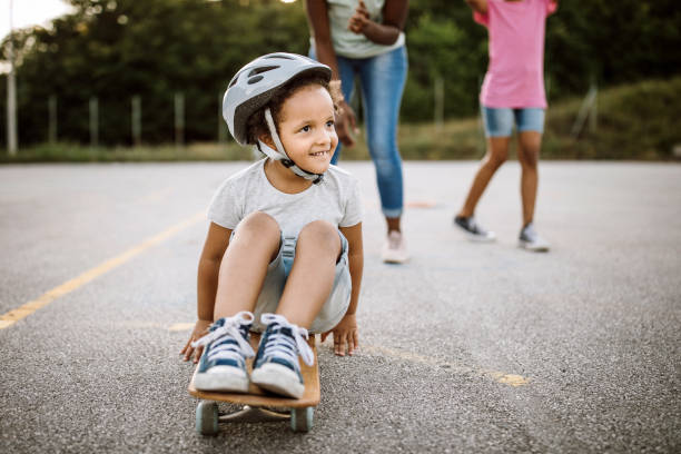 istock Little African girl having fun on skateboard 1168485418