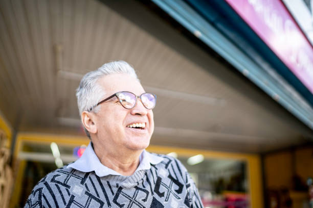 istock Happy senior man in front of a store looking away 1168488506
