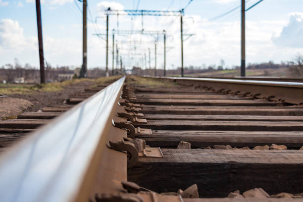 Railway with rails on wooden sleepers Close-up of railway rails on wooden sleepers. Smooth, mirrored surface rails on which trains often pass railroad track concrete railway sleeper thoroughfare stock pictures, royalty-free photos & images