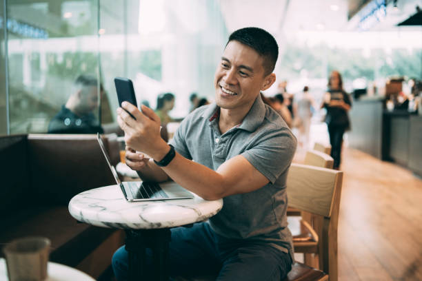 istock Man using laptop and smart phone in cafe 1168488713