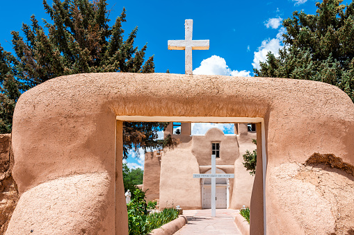 Ranchos de Taos St Francic Plaza and San Francisco de Asis church with cross and gate in New Mexico