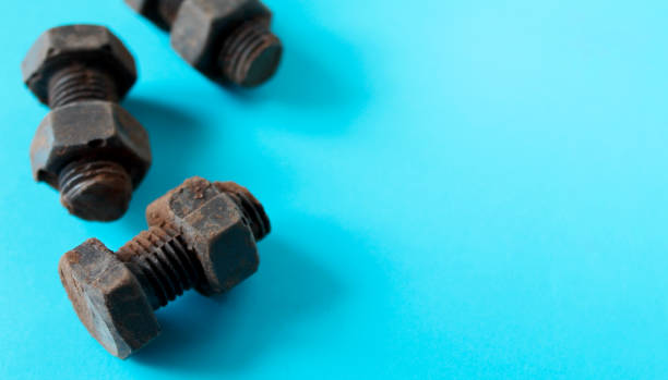 istock Rusty bolts and nuts made of chocolate isolated on sky blue background. 1168494232
