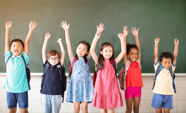 istock Group of diverse young students standing together in classroom 1168505057