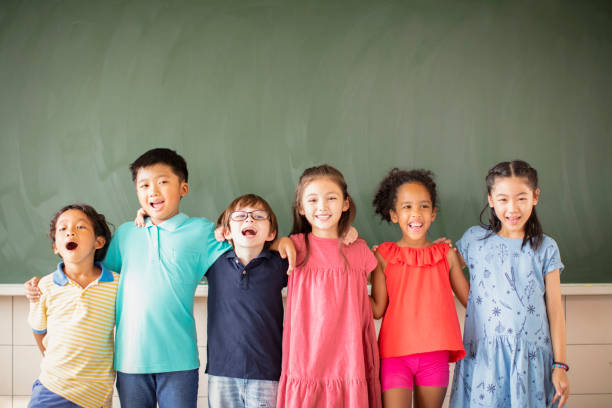 istock Multi-ethnic group of school children standing in classroom 1168505081