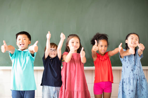 istock Multi-ethnic group of school children standing in classroom 1168505124