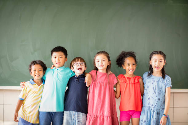istock Multi-ethnic group of school children standing in classroom 1168505127