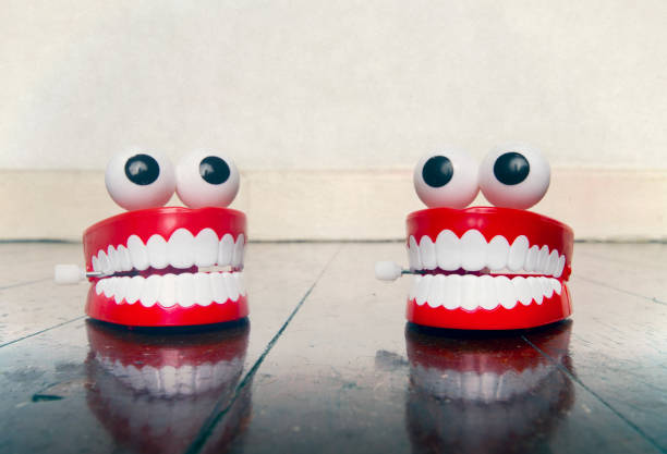 istock two platic teeth toys chatting on a old wooden floor 1168508109