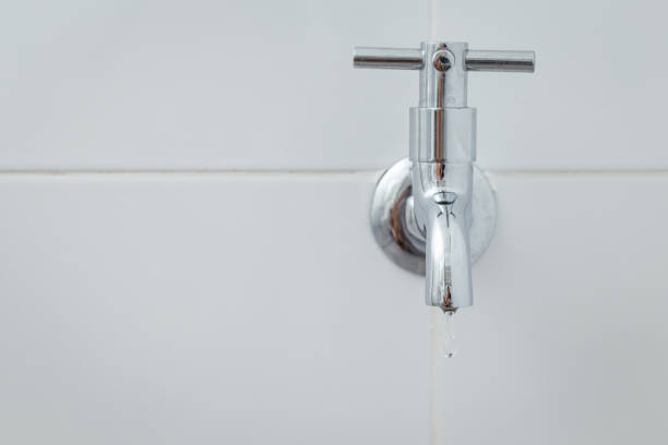 istock Silver metal faucet on white tile floor 1168509689