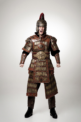 Adult male wearing very old armor.