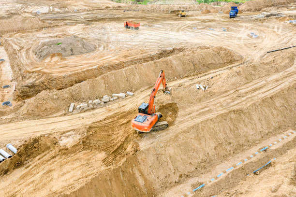 istock view of industrial excavator and dump trucks working at construction site 1168514908