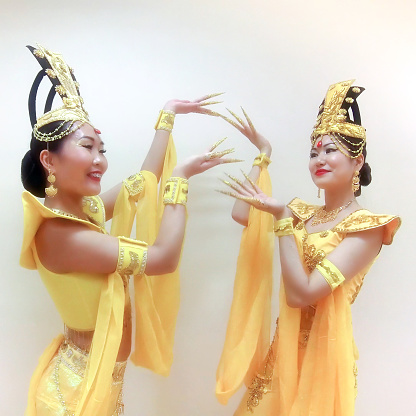 Two beautiful asian women doing pa with hands, with long false nails, close up portrait