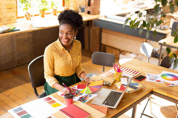 istock Creative manager sitting near laptop and smiling having inspiration 1168517353